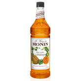 Monin Rock Melon Cantaloupe syrup bottle pouring into a glass for cocktails