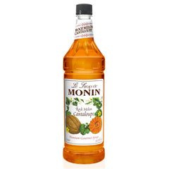 Monin Rock Melon Cantaloupe syrup bottle pouring into a glass for cocktails