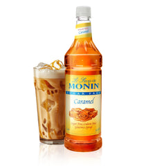 Monin Sugar Free Caramel syrup bottle pouring over coffee for latte sweetness
