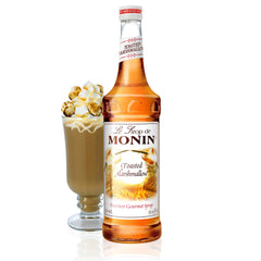Monin Toasted Marshmallow Syrup bottle pouring into a latte for campfire-inspired flavor.