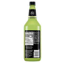 Pouring Mr & Mrs T mix into a glass for a tangy margarita.
