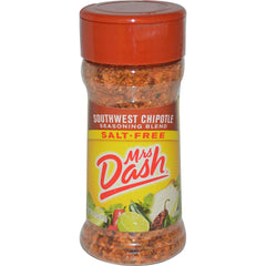 Mrs. Dash Southwest Chipotle seasoning bottle pours smoky flavor onto grilled chicken.
