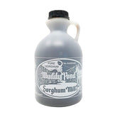 Muddy Pond Sorghum Mill bottle pouring syrup on warm biscuits.