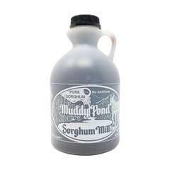 Muddy Pond Sorghum Mill bottle pouring syrup on warm biscuits.