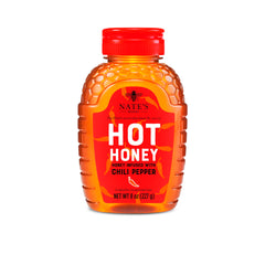 Nate's Hot Honey bottle pour enhances pizzas, cocktails, and drizzle flavor.