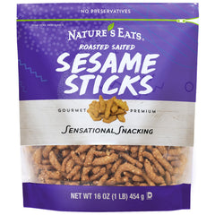 Nature's Eats Sesame Sticks 16oz pack on a wooden board, ideal for on-the-go snacking.