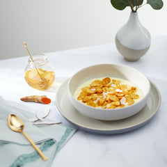Milk being poured over Golden Turmeric Cereal for easy breakfast preparation