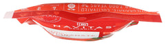Navitas Organics Pomegranate Powder on a spoon beside a yogurt bowl for toppings