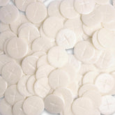 Needzo altar bread with white cross design, ideal for Eucharist rites.