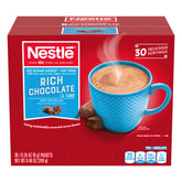 Nestle Hot Cocoa no sugar added dispenser box on a clean counter for easy serving.
