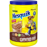 Nestle Nesquik chocolate powder canister on a kitchen shelf for quick chocolate milk.