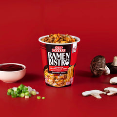 A bowl-level view of NISSIN Ramen Bistro with bok choy and vegetables.