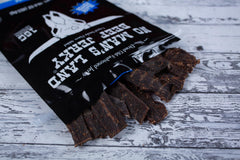 No Man's Land Beef Jerky in hand, ideal outdoor snack for energy.