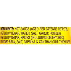 Pouring OLD BAY Hot Sauce for a spicy kick