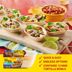 Mini tortilla bowls filled with meat and toppings for a tasty bite