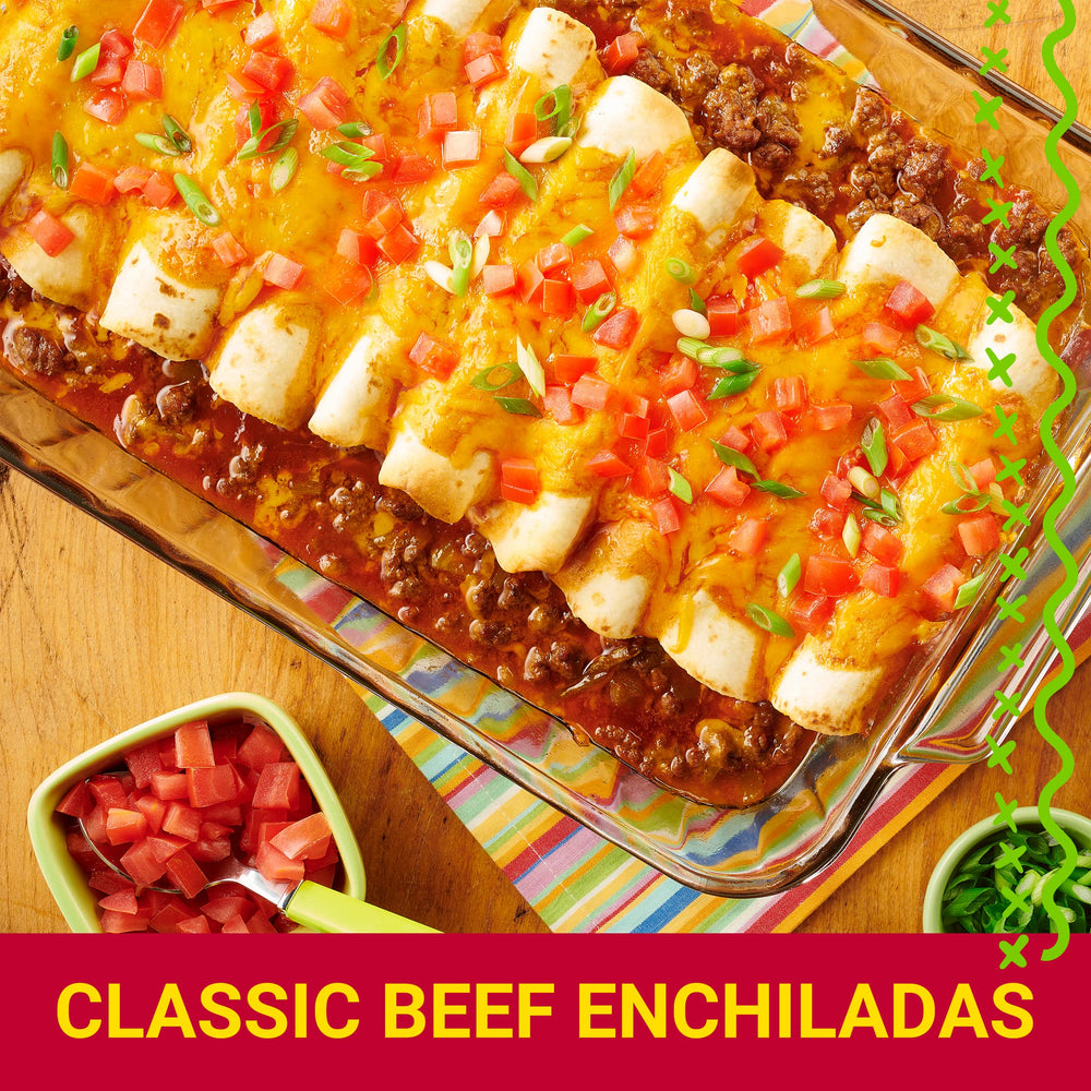Sizzling skillet with seasoned beef and peppers.