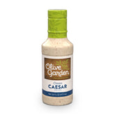 Olive Garden Classic Caesar Dressing bottle showing creamy texture for salads and meals.