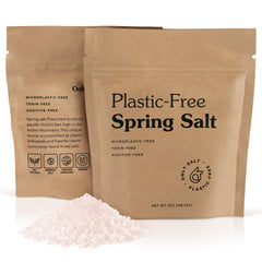Only Ancient Spring Salt flakes spread on a surface with a subtle earthy glow.