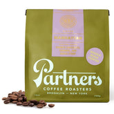 Partners Coffee Roasters Manhattan Blend bag highlighting bold chocolate and caramel notes.