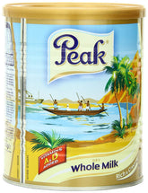 Peak Milk Powder canister on kitchen shelf for rich, creamy drinks