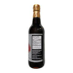 Pouring Pearl River Bridge dark soy sauce enhances depth in sauces.