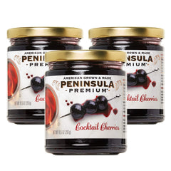 Peninsula Premium Cocktail Cherries bottle pour highlights rich cherry flavor and silky syrup.