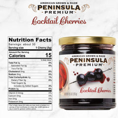 Close-up of Peninsula Premium Cocktail Cherries jar, rich burgundy color and silky syrup.