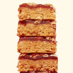 Perfect Bar Fruit Crisp Mixed Berry bar cross-section reveals quinoa crisps and honey sweetness.