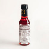 PEYCHAUD'S aromatic bitters bottle enhances flavor in classic cocktails
