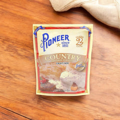Serving Pioneer Country Sausage Gravy over mashed potatoes at breakfast.