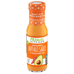 Primal Kitchen No Dairy Buffalo Sauce bottle pour shows creamy, dairy-free heat for wings