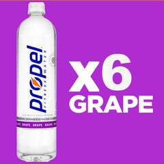 Chilled Propel Grape bottle on a gym bag for on-the-go hydration.
