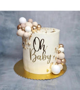 QPARTYFIRE Oh Baby gold acrylic cake topper enhancing a baby shower cake with elegance