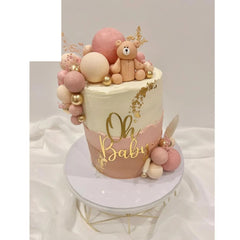 QPARTYFIRE Oh Baby cake topper with script font on a pastel cake for baby shower