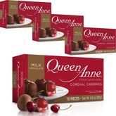 Queen Anne milk chocolate covered cordial cherries on a plate; creamy centers make a delightful bite.
