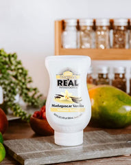 Reàl Infused Exotics Vanilla Syrup bottle used in baking and desserts.