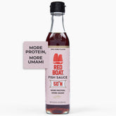 Red Boat Phamily Reserve bottle beside a wooden barrel signaling premium fermentation and depth