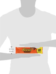 A hand holds a Reese's King Size Cup, ready for sharing.
