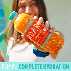 ROAR Organic Mango Clementine glass with ice highlighting vibrant flavor.