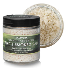 Saltverk birch smoked sea salt bottle on kitchen shelf, premium flavor ready to finish dishes.