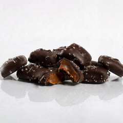 Close-up of Sanders Dark Chocolate Sea Salt Caramel Minis, glossy coating and salt crystals, great snack.