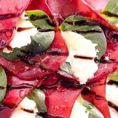 Sanniti Saba being poured over fresh fruit for a bright finish