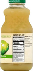 Pouring Santa Cruz Organic Lime Juice into a glass with ice for refreshment.