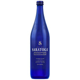 Saratoga Sparkling Water 28oz blue bottle on a table, ideal for sharing.