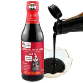 Sauce Grandmaster dark soy bottle pouring for rich glaze and color.