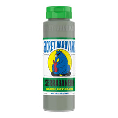 Secret Aardvark Serrabanero hot sauce bottle pouring adds bold heat to tacos.