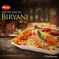 Shan Biryani Masala spice blend on a wooden spoon for effortless biryani seasoning.