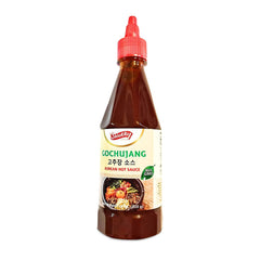Shirakiku Gochujang bottle pouring sauce for quick flavor boost.