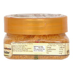 Shudh India Hing powder with a spoon for easy onion substitute.
