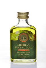 Siberian Treasure pine nut oil being poured for culinary use